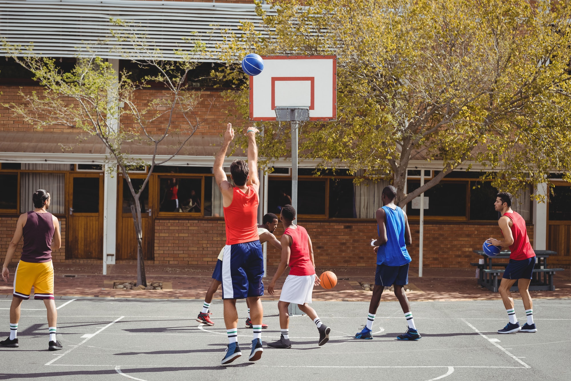 Basketball players practicing in basketball court